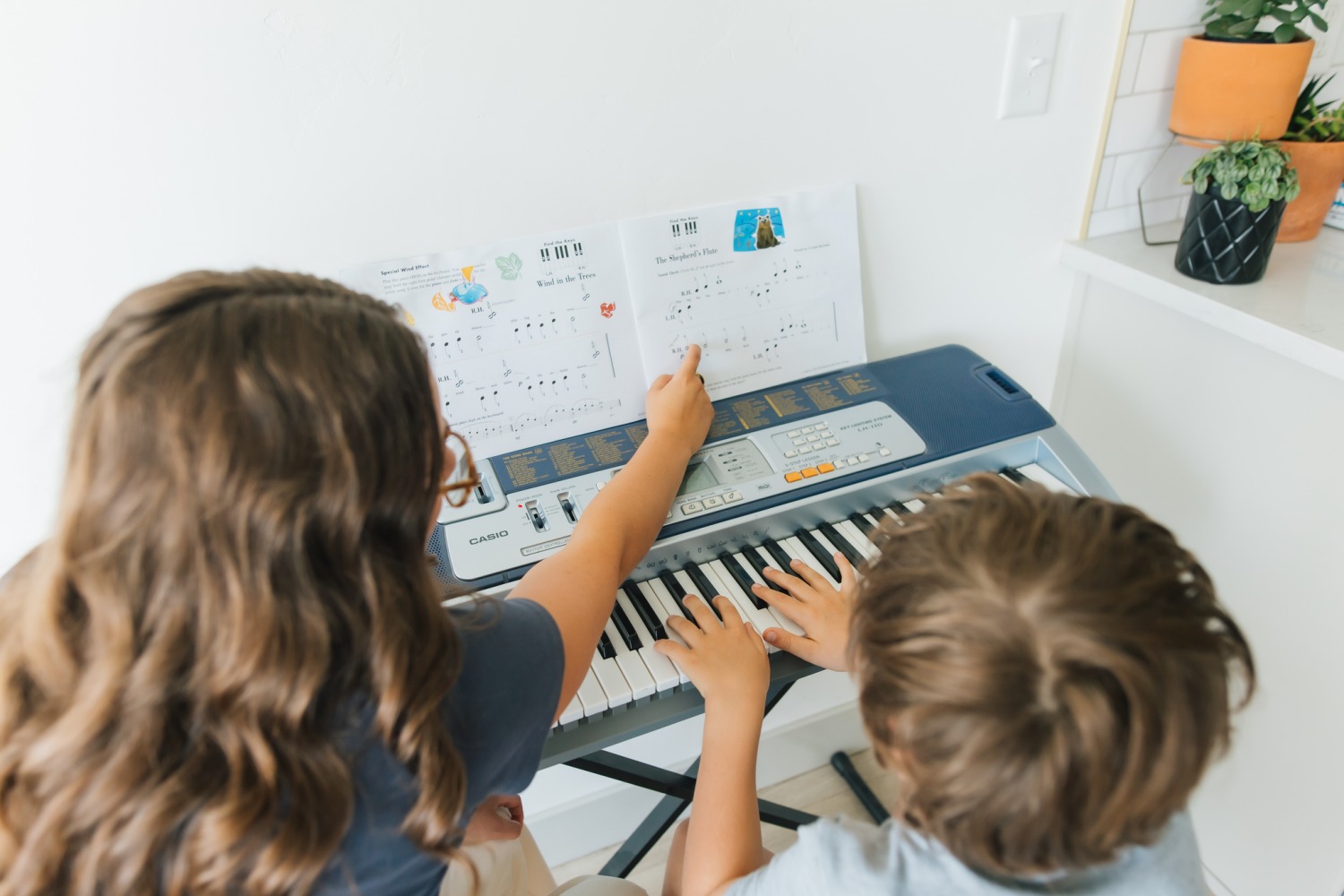 Teacher explaining music sheet to student